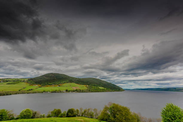 View of the amazing Loch Ness taken from Urquhart Castle View of loch ness surrounded by hills and villages from the top of Urquhart Castle. drumnadrochit stock pictures, royalty-free photos & images