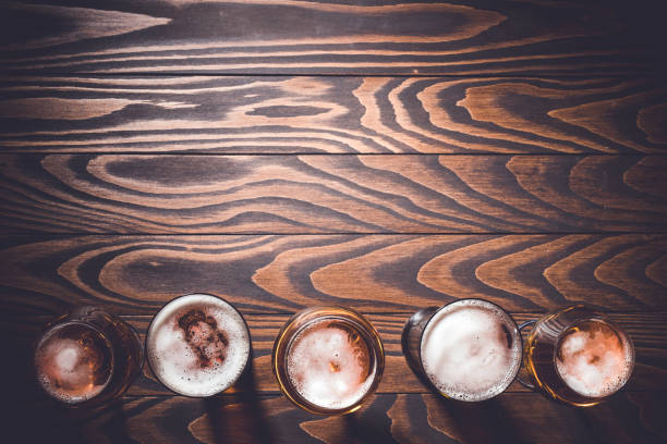 istock Beer glasses on an old dark wooden table. 698008806