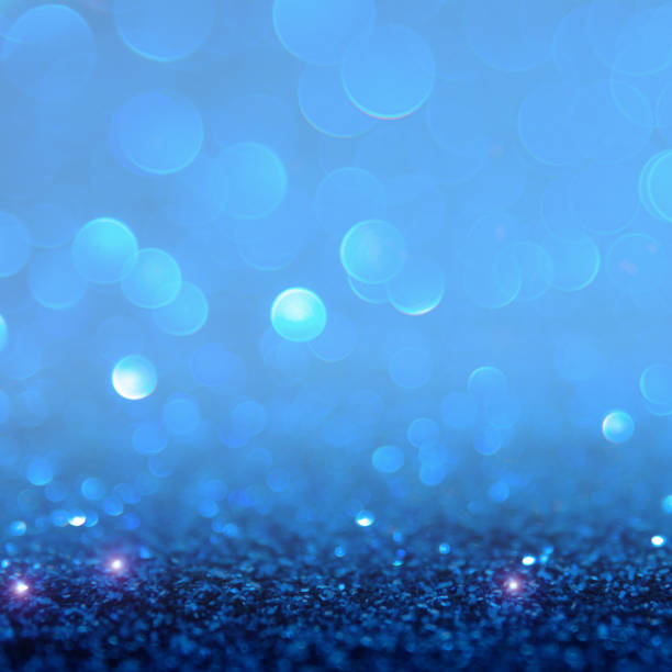 istock Blue bokeh light is the soft blurred circles of light white and light blue . Winter Christmas background texture Wallpaper concept 698009132
