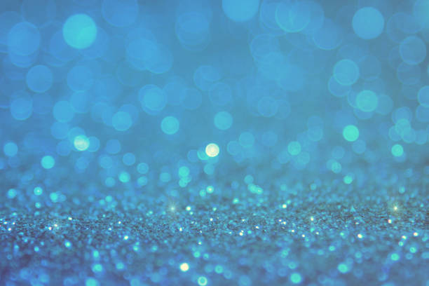 istock Blue bokeh light is the soft blurred circles of light white and light blue . Winter Christmas background texture Wallpaper concept 698016054