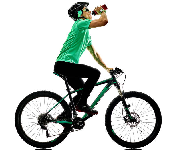 istock tenager boy  mountain bike bking drinking isolated shadows 698017530