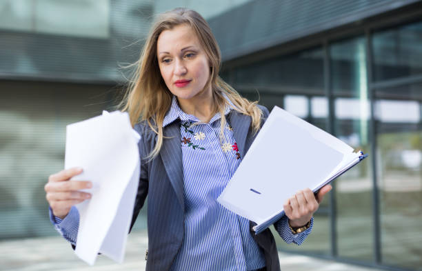 istock Employee woman with folder of documents 698022332