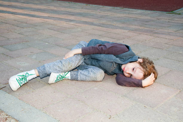 istock Sad boy with broken leg after running in park 698022486