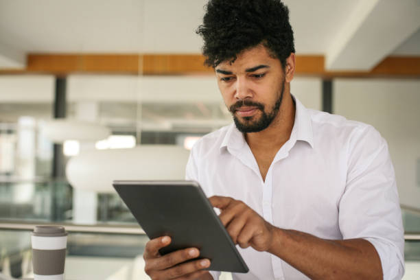 istock African American business man using digital tablet at the office. African man working on tablet. 698022966