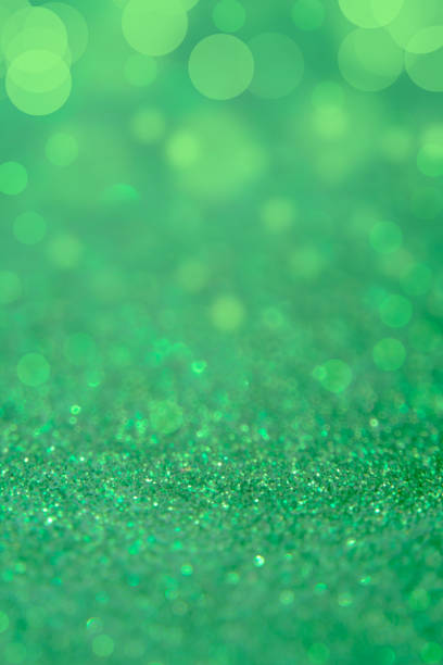 istock Green glitter abstract background with bokeh defocused lights 698023230