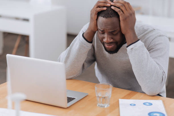 istock Cheerless moody man suffering from headache 698025576
