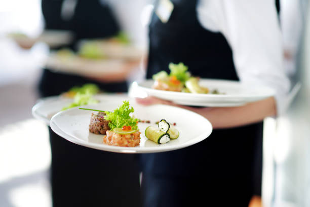 istock Waiter carrying plates with meat dish 698025620