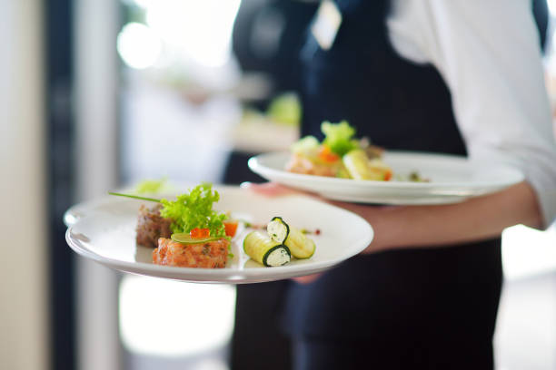 istock Waiter carrying plates with meat dish on some festive event 698025644
