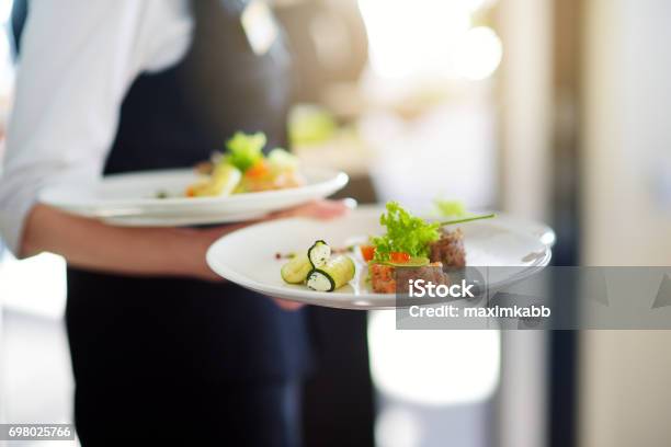 Waiter Carrying Plates With Meat Dish On Some Festive Event Stock Photo - Download Image Now