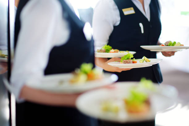 istock Waiter carrying plates with meat dish on some festive event 698025802