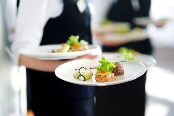 istock Waiter carrying plates with meat dish 698025832