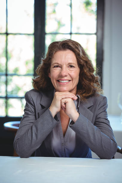 istock Smiling businesswoman leaning on a table 698030564