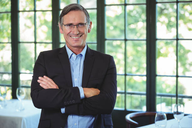 istock Smiling businessman posing with crossed arms 698031322