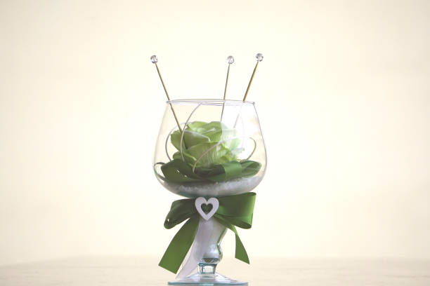 Rose in the crystal Yellow silk rose with green ribbon inside a crystal chalice. crystal chalice stock pictures, royalty-free photos & images