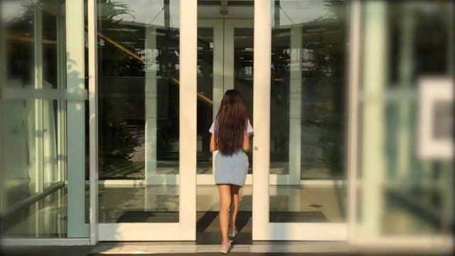 woman entering the shopping mall  door