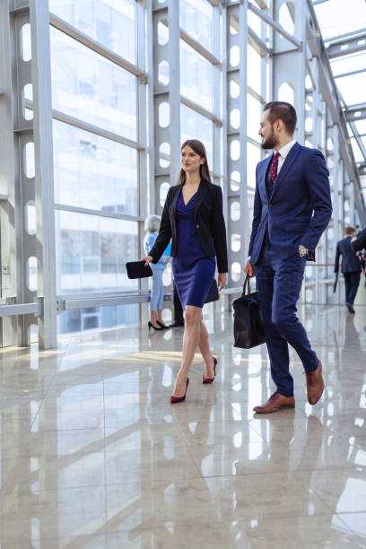 istock Business people walking in office corridor 698034158