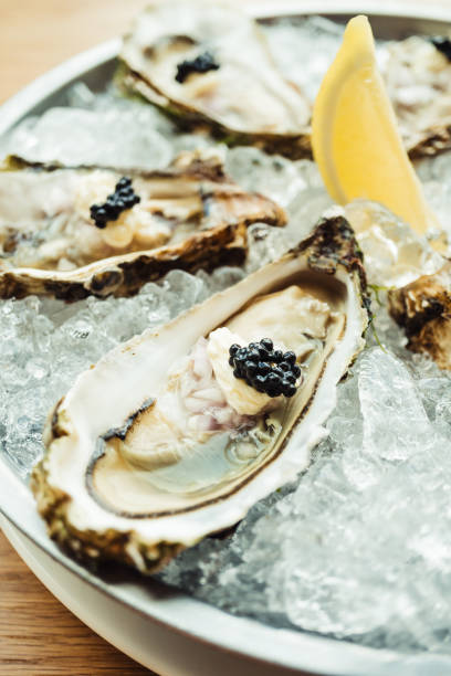 istock Raw and fresh Oyster with caviar on top and lemon 698034234