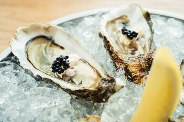 istock Raw and fresh Oyster with caviar on top and lemon 698034454