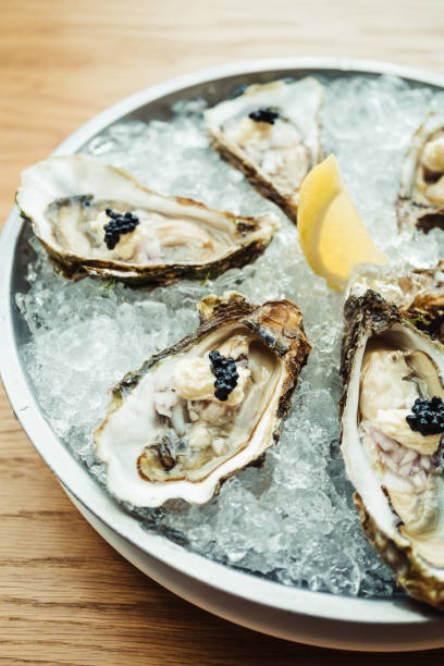 istock Raw and fresh Oyster with caviar on top and lemon 698035010