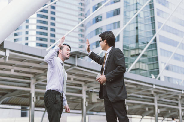 istock Business celebration for good teamwork with a high-five 698035190