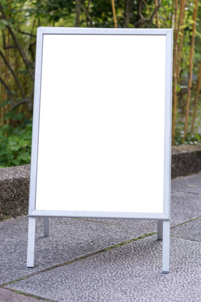 istock Blank ad space sign infront of trees in a park on the ground 698041100
