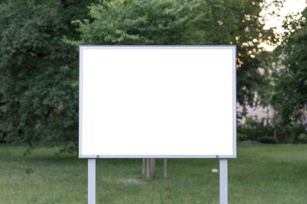 istock Blank ad space sign infront of trees in a park 698041194
