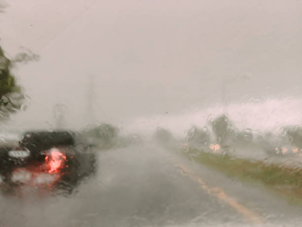 istock abstract blur : rain drop on car window , see backside car no clear , careful for dangerous on raining season 698047394