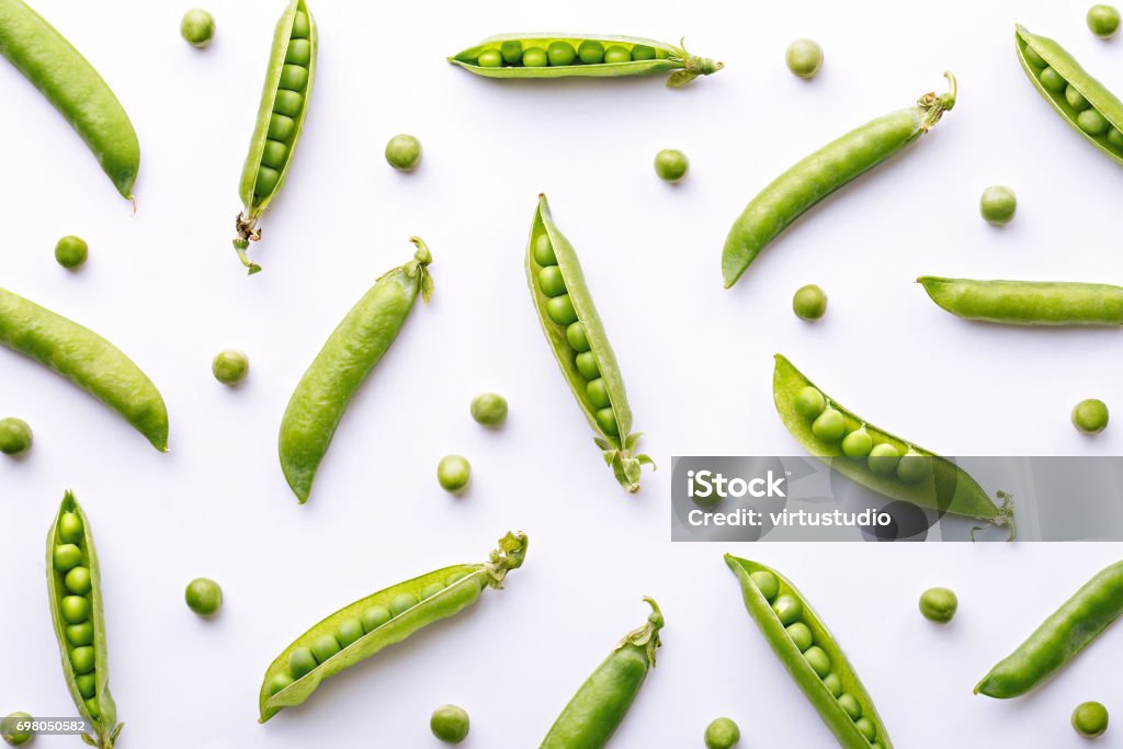 Peas pattern. Top view of fresh vegetable on a white background. Repetition concept Green Pea Stock Photo