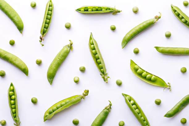 Peas pattern. Top view of fresh vegetable on a white background. Repetition concept stock photo