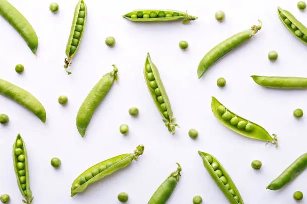 Photo of Peas pattern. Top view of fresh vegetable on a white background. Repetition concept