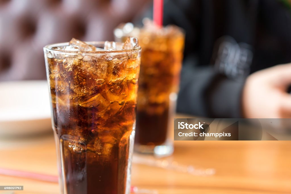 Soft drink on wooden table and men sitting Soda Stock Photo