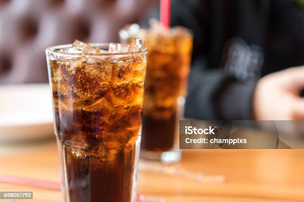 Soft Drink On Wooden Table And Men Sitting Stock Photo - Download Image Now - Soda, Cola, Carbonated