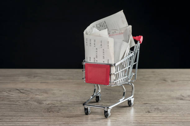 Shopping trolley with receipts Close up shot of a tiny shopping trolley filled with receipts bowie seamount stock pictures, royalty-free photos & images