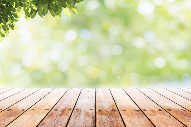istock Empty wooden table with party in garden background blurred. 698058884