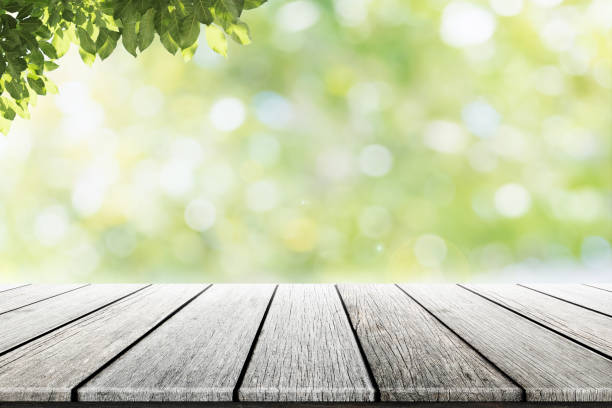 istock Empty wooden table with party in garden background blurred. 698059136