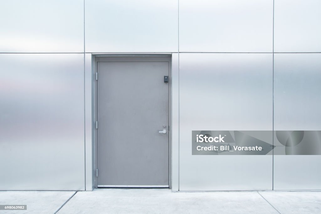 close grey door with aluminium or steel wall Door Stock Photo