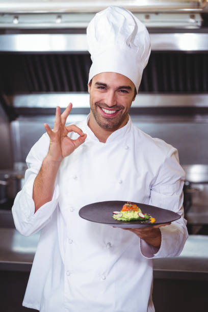 istock Male chef holding plate and doing ok sign 698073304