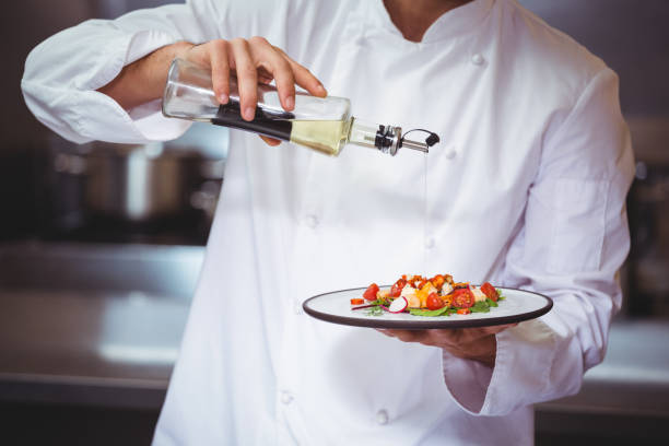 istock Chef putting finishing touch on salad 698073372
