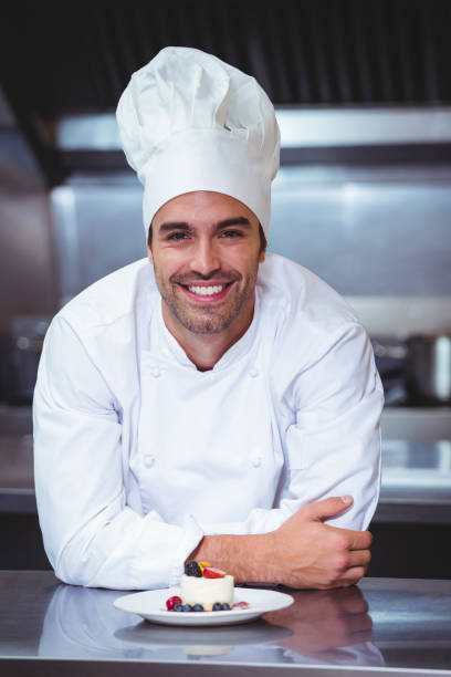 istock Chef leaning on the counter with a dessert 698075616