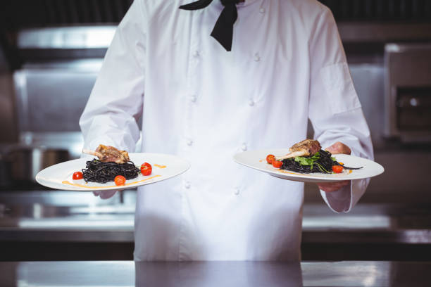 istock Chef showing plates of spaghetti 698076614