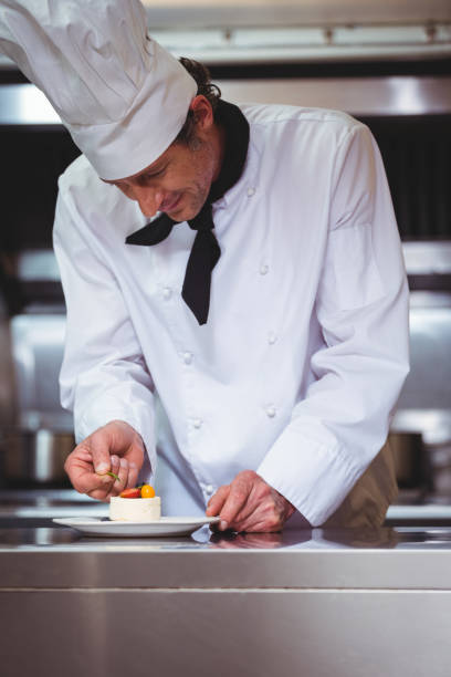 istock Chef putting finishing touch on dessert 698077570