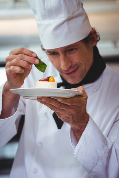 istock Chef putting finishing touch on dessert 698077804
