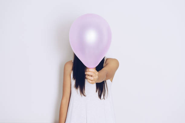 istock Woman holds balloons in a white background 698091744