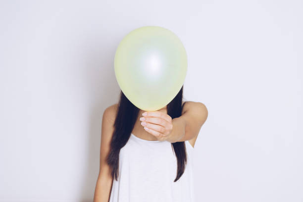istock Woman holds balloons in a white background 698092226