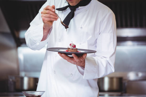 istock Chef putting chocolate sauce on a dessert 698094574