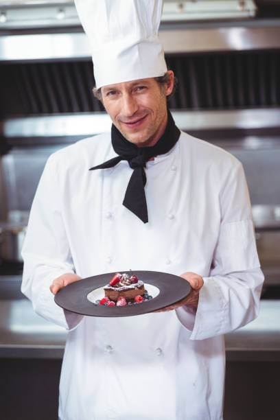 istock Chef holding a plate with a dessert 698094688