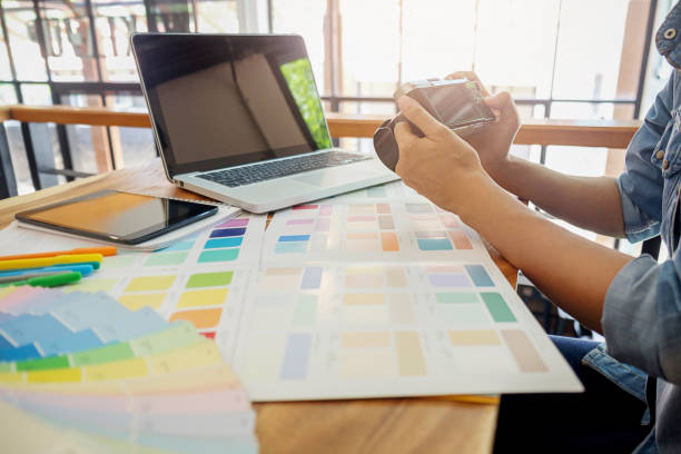 istock Graphic designers are looking at the camera at work. 698095134