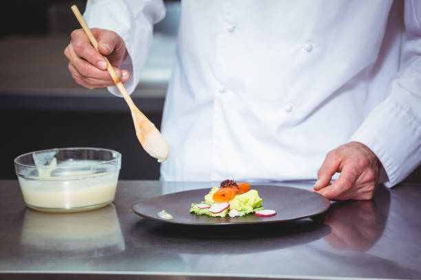 istock Chef putting chocolate sauce on a dessert 698095154