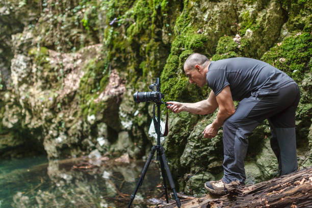 istock Professional landscape photographer by the lake 698099322