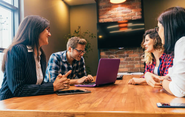 istock Happy young people having a business meeting 698102848